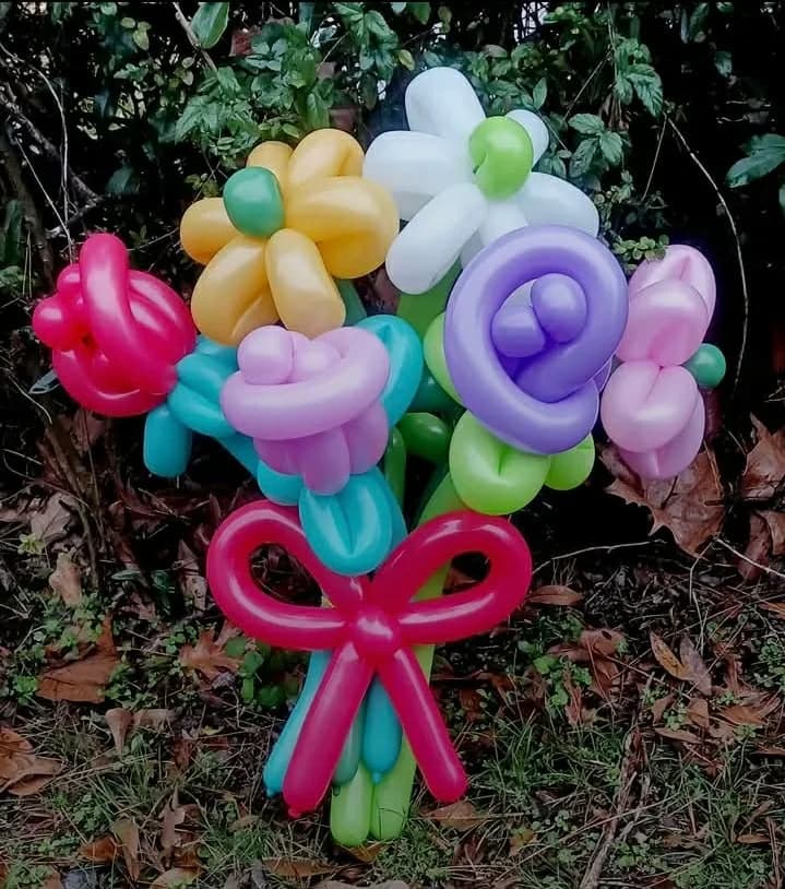 Colorful balloon flower bouquet with a red balloon bow