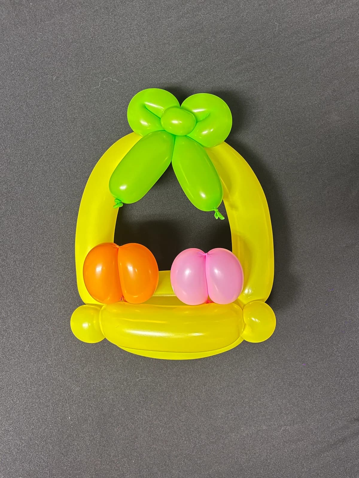 Green balloon basket with colorful eggs