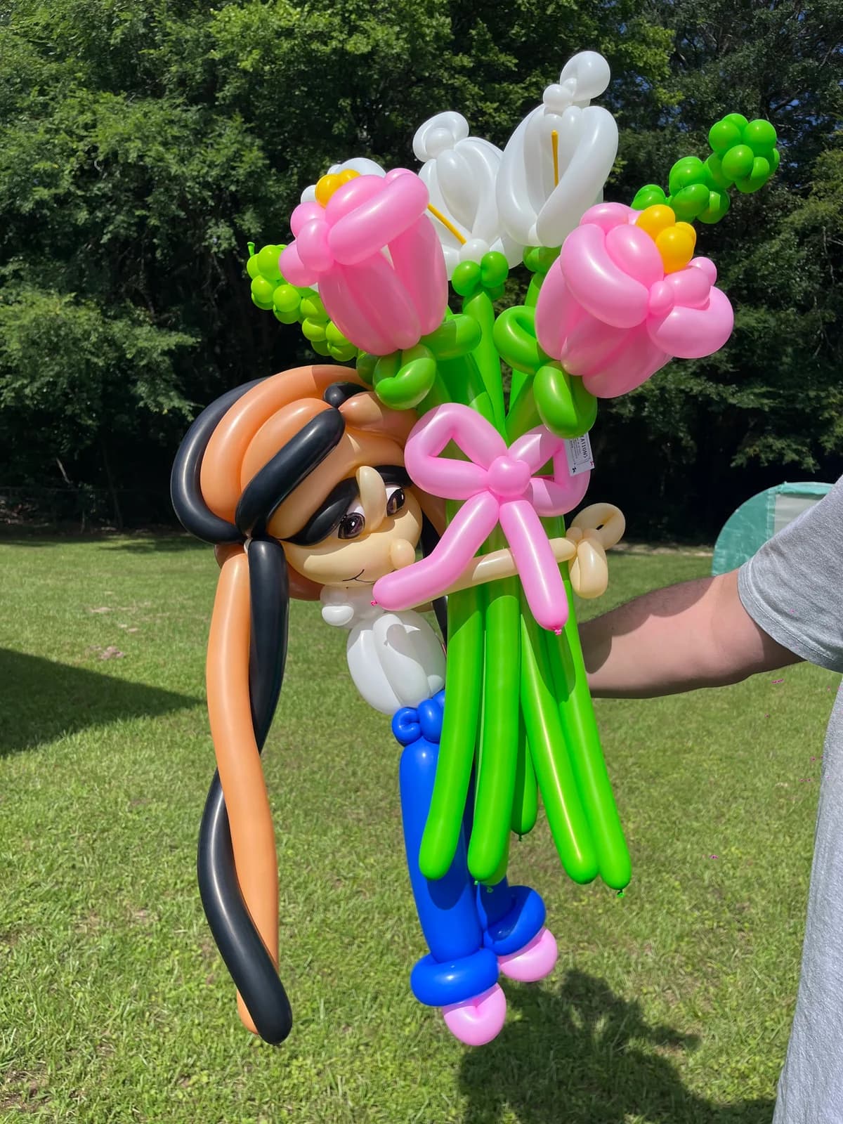Personalized balloon caricature in a large colorful flower bouquet